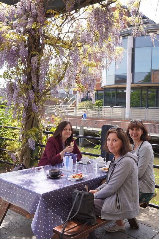Picture of some of The Cafe Project customers enjoying falafel by the river.