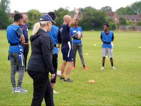 Image of people outdoors coaching rugby