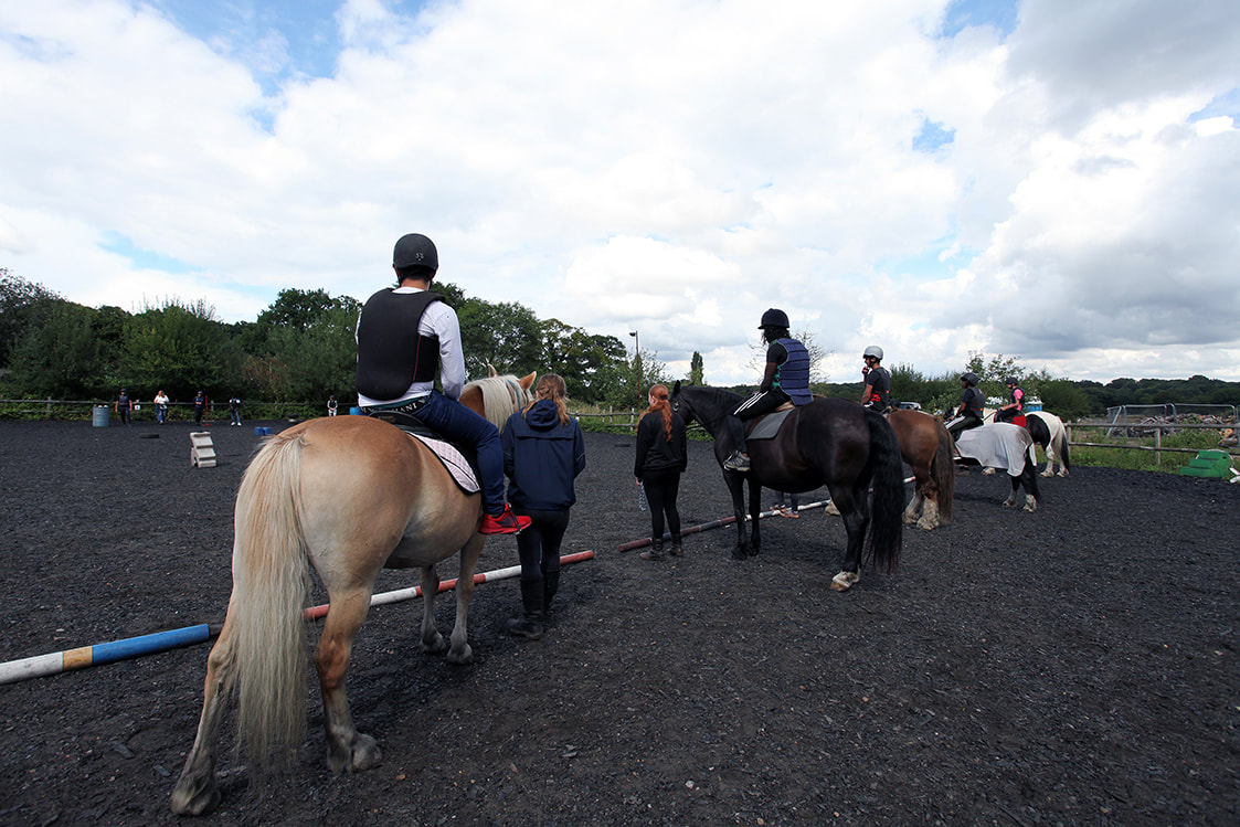 Picture of a group of young people riding in the paddock at The Heart Centre © Big Leaf Foundation